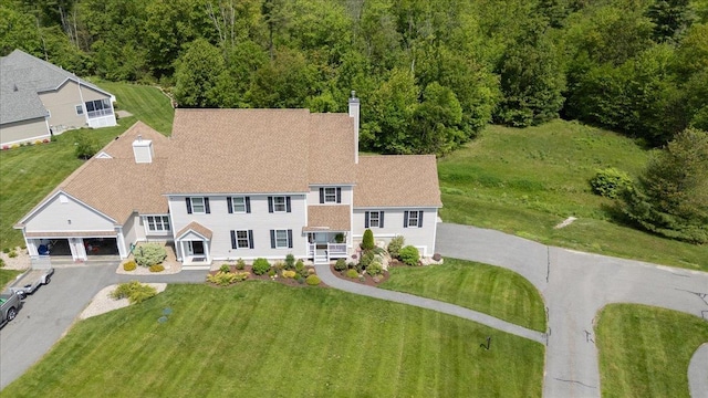 38 Granite Ln Unit 38, Chester, NH 03036 - view of front of house featuring driveway, a chimney, a front lawn, and a shingled roof