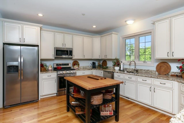 38 Granite Ln Unit 38, Chester, NH 03036 - kitchen with stainless steel appliances, a sink, butcher block counters, light wood-type flooring, and recessed lighting