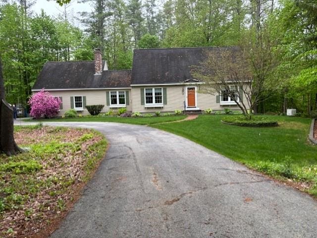 3 Dove St, Wolfeboro, NH 03894 - view of front facade with curved driveway, a front lawn, and a chimney