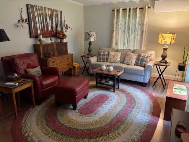 3 Dove St, Wolfeboro, NH 03894 - living area with a wall mounted air conditioner, wood finished floors, and crown molding