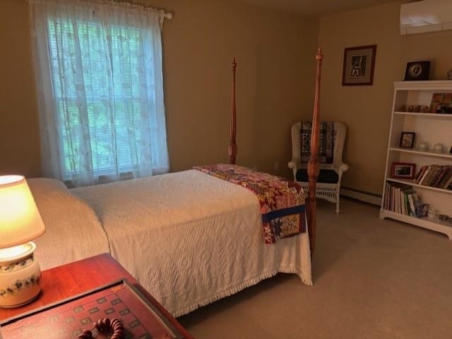 3 Dove St, Wolfeboro, NH 03894 - carpeted bedroom with a baseboard radiator