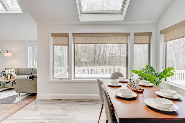 270 Beechnut Dr, Conway, NH 03860 - dining room with a skylight, plenty of natural light, wood finished floors, baseboards, and vaulted ceiling
