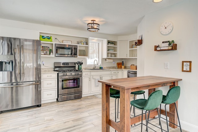 270 Beechnut Dr, Conway, NH 03860 - kitchen with stainless steel appliances, open shelves, a sink, wooden counters, and white cabinets
