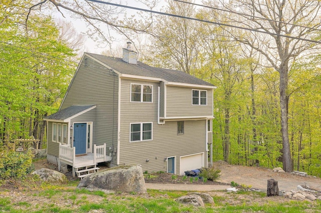 270 Beechnut Dr, Conway, NH 03860 - rear view of property featuring a chimney, a garage, a deck, and roof with shingles