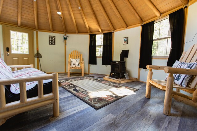 2554 Hurricane Mountain Rd, Conway, NH 03813 - bedroom featuring a wood stove, wood finished floors, wooden ceiling, and baseboards