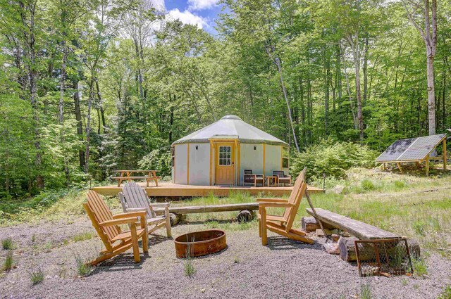 2554 Hurricane Mountain Rd, Conway, NH 03813 - view of playground with an outdoor fire pit, a view of trees, and a wooden deck