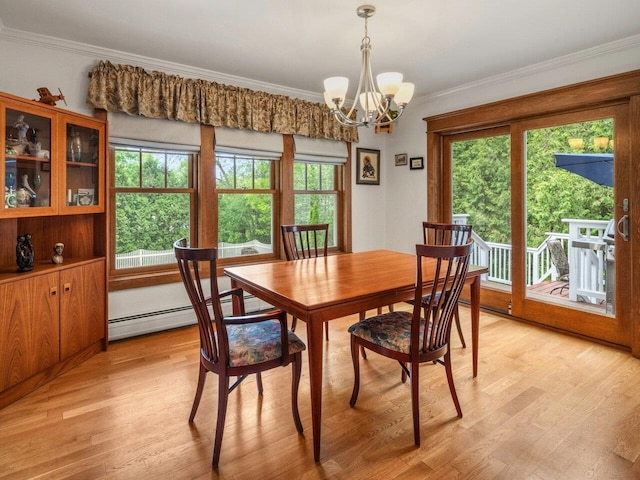 278 S Cove Rd, Burlington, VT 05401 - dining space with a baseboard radiator, a chandelier, ornamental molding, plenty of natural light, and light wood-style flooring