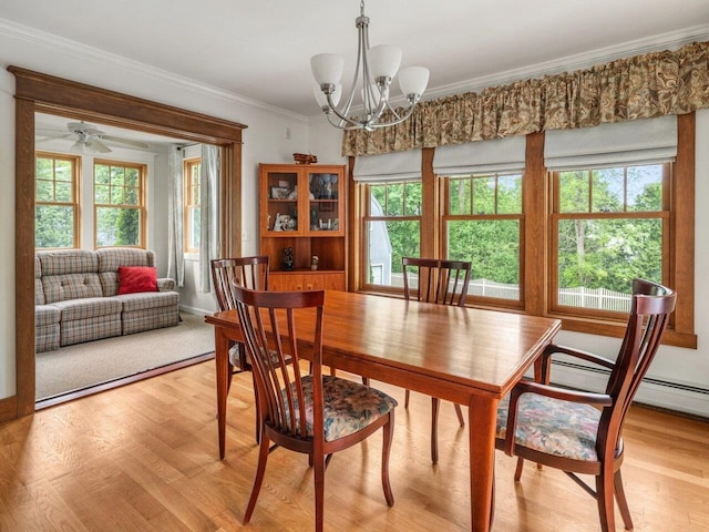 278 S Cove Rd, Burlington, VT 05401 - dining space with a chandelier, crown molding, light wood-type flooring, and baseboards
