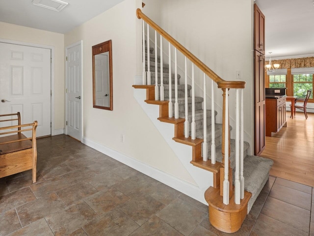 278 S Cove Rd, Burlington, VT 05401 - stairway with baseboards, a chandelier, and a baseboard heating unit