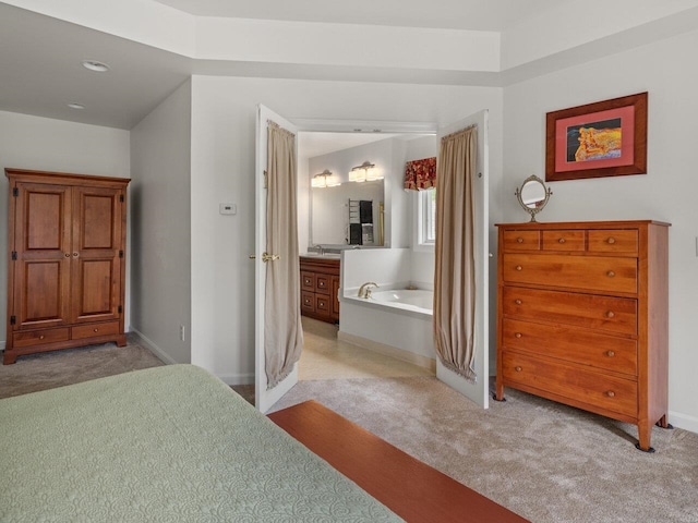 278 S Cove Rd, Burlington, VT 05401 - bedroom with light carpet, baseboards, a sink, and connected bathroom