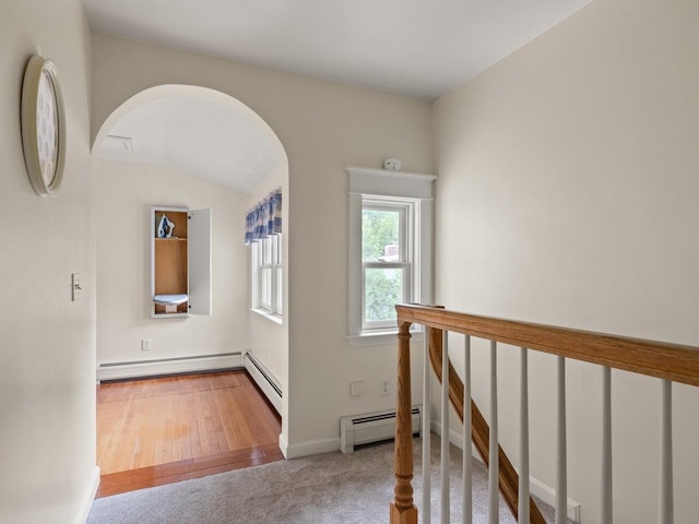 278 S Cove Rd, Burlington, VT 05401 - hallway featuring a baseboard radiator, arched walkways, and carpet flooring