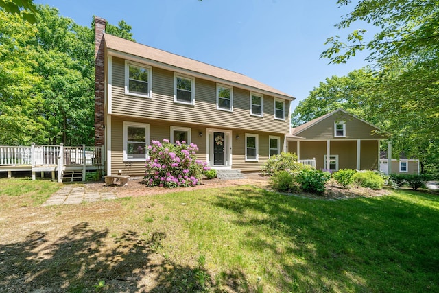 78 Hitching Post Ln, Bedford, NH 03110 - colonial house with a chimney, a front lawn, and a deck