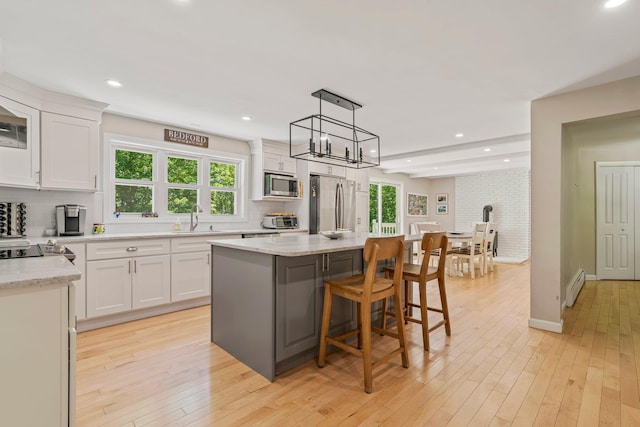 78 Hitching Post Ln, Bedford, NH 03110 - kitchen with appliances with stainless steel finishes, a baseboard heating unit, backsplash, a sink, and recessed lighting