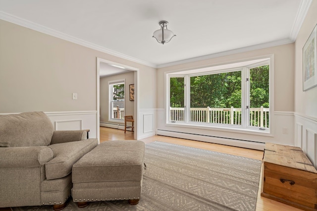 78 Hitching Post Ln, Bedford, NH 03110 - living area with baseboard heating, wainscoting, crown molding, a decorative wall, and wood finished floors