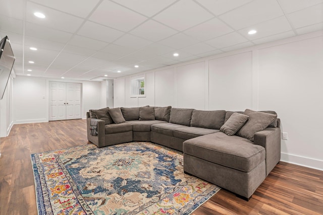 78 Hitching Post Ln, Bedford, NH 03110 - living room featuring wood finished floors, baseboards, a drop ceiling, a decorative wall, and recessed lighting