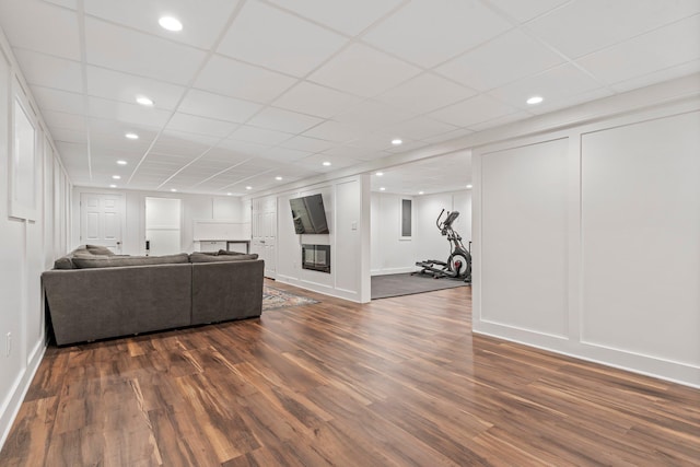 78 Hitching Post Ln, Bedford, NH 03110 - living area with dark wood-style flooring, recessed lighting, a drop ceiling, and baseboards