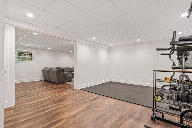78 Hitching Post Ln, Bedford, NH 03110 - workout room featuring dark wood-style flooring, a paneled ceiling, a decorative wall, and baseboards