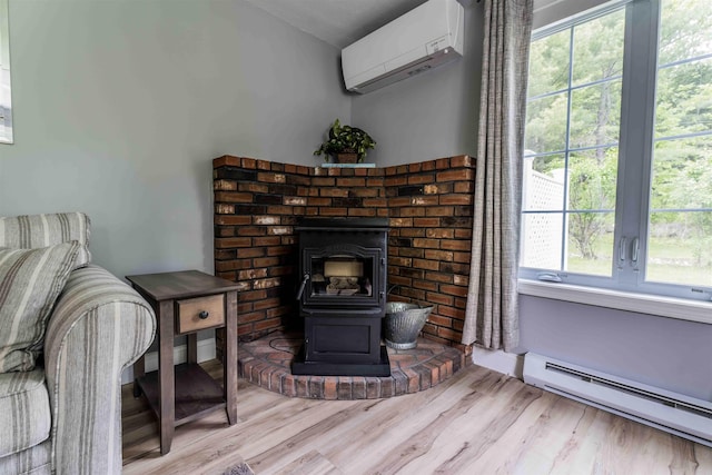 82 Garden Cir, Laconia, NH 03246 - living area with a baseboard radiator, a wall mounted AC, a wood stove, wood finished floors, and lofted ceiling