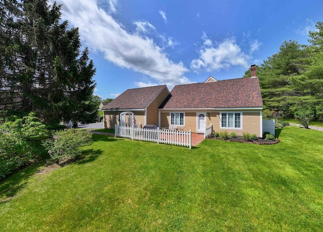 82 Garden Cir, Laconia, NH 03246 - back of property featuring a yard, a patio, a chimney, and roof with shingles
