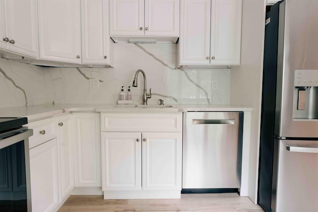 82 Garden Cir, Laconia, NH 03246 - kitchen with stainless steel appliances, a sink, tasteful backsplash, and white cabinetry