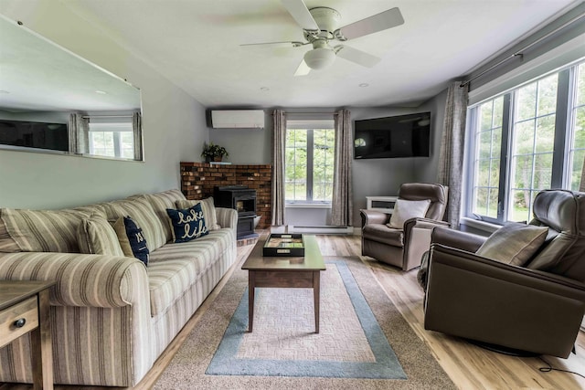 82 Garden Cir, Laconia, NH 03246 - living room featuring an AC wall unit, plenty of natural light, a baseboard heating unit, and wood finished floors