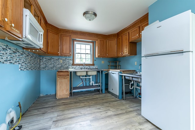 2 Ramsey Dr, Rochester, NH 03839 - kitchen with white appliances, brown cabinetry, light wood-type flooring, and decorative backsplash