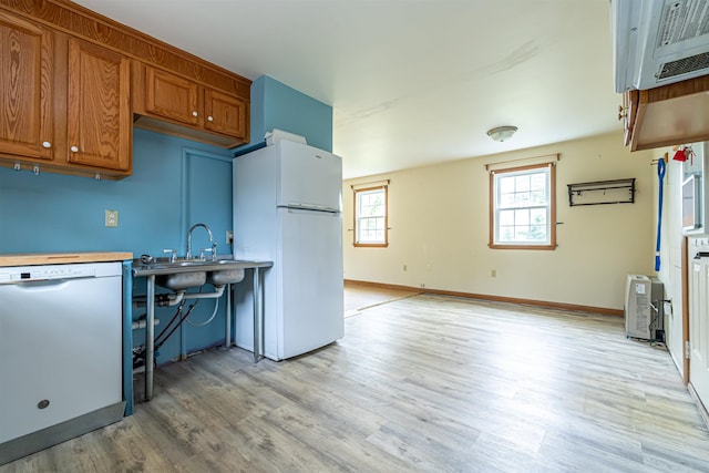 2 Ramsey Dr, Rochester, NH 03839 - kitchen with white appliances, light wood finished floors, brown cabinetry, a sink, and light countertops