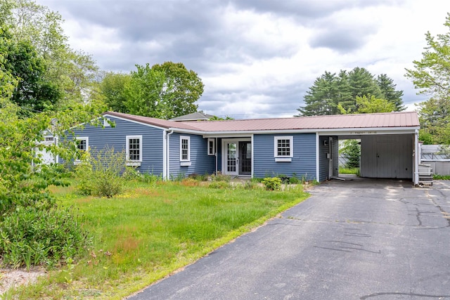 2 Ramsey Dr, Rochester, NH 03839 - ranch-style home with metal roof, asphalt driveway, and a carport