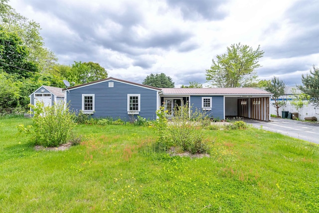 2 Ramsey Dr, Rochester, NH 03839 - view of front of house featuring asphalt driveway, metal roof, an attached carport, and a front yard