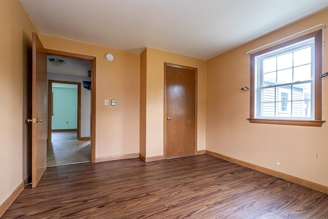2 Ramsey Dr, Rochester, NH 03839 - unfurnished bedroom with dark wood-style floors, baseboards, and a closet