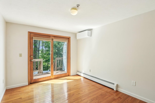 620 Hackett Hill Rd, Manchester, NH 03102 - unfurnished room with baseboard heating, a wall mounted air conditioner, hardwood / wood-style floors, and baseboards