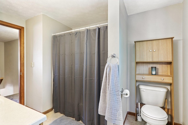 620 Hackett Hill Rd, Manchester, NH 03102 - bathroom with baseboards, toilet, vanity, tile patterned floors, and a shower with shower curtain