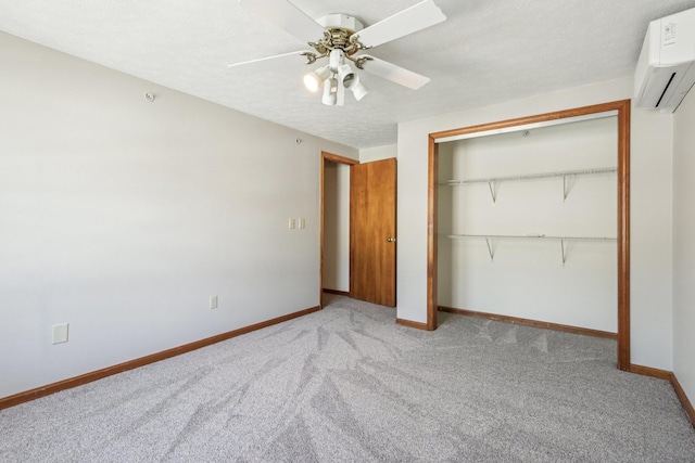 620 Hackett Hill Rd, Manchester, NH 03102 - unfurnished bedroom with a wall mounted air conditioner, carpet floors, baseboards, a closet, and a ceiling fan