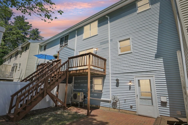 620 Hackett Hill Rd, Manchester, NH 03102 - back of house at dusk with a patio, ac unit, and stairway