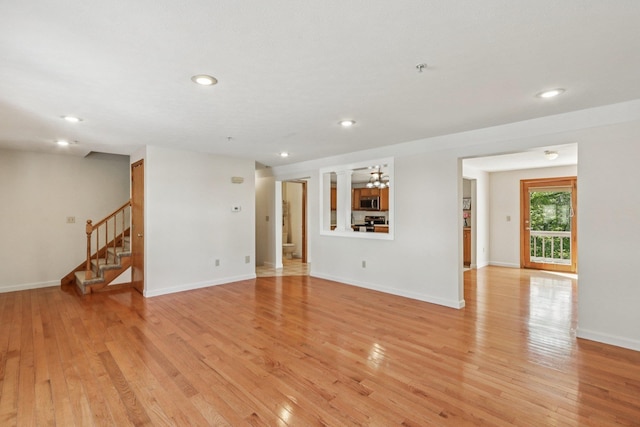620 Hackett Hill Rd, Manchester, NH 03102 - unfurnished room with stairs, light wood finished floors, recessed lighting, baseboards, and ornate columns