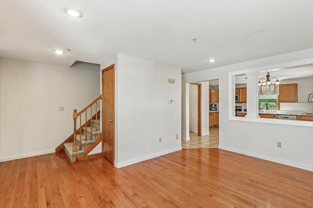 620 Hackett Hill Rd, Manchester, NH 03102 - unfurnished living room featuring a chandelier, light wood-style floors, a sink, stairs, and recessed lighting