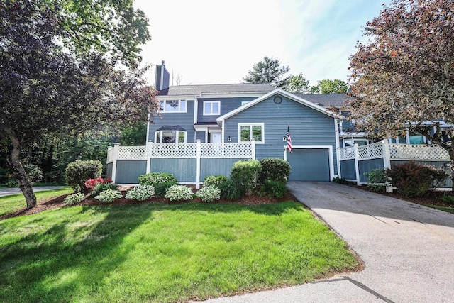58 Hickory Ln, Windham, NH 03087 - view of front of home with driveway, a chimney, and an attached garage