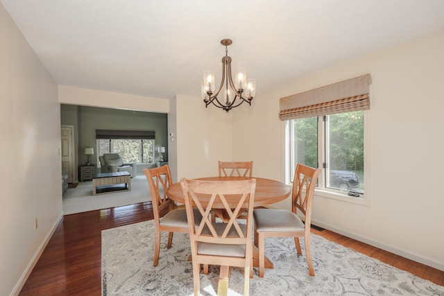 58 Hickory Ln, Windham, NH 03087 - dining space with a chandelier, healthy amount of natural light, dark wood-type flooring, and baseboards