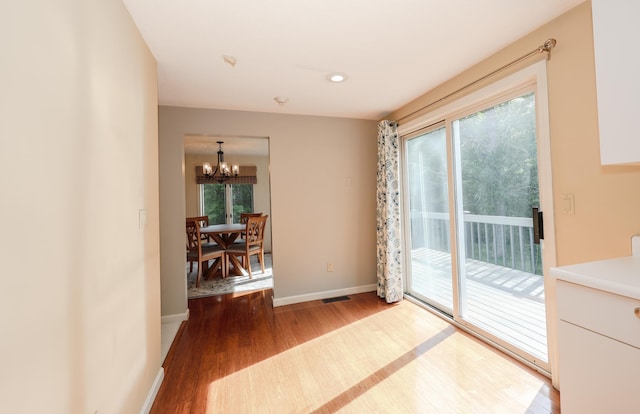 58 Hickory Ln, Windham, NH 03087 - doorway with a chandelier, wood finished floors, healthy amount of natural light, and baseboards