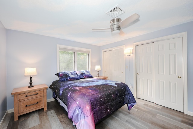 58 Hickory Ln, Windham, NH 03087 - bedroom featuring multiple closets, light wood-style floors, baseboards, and a ceiling fan