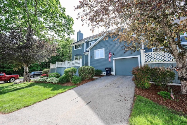 58 Hickory Ln, Windham, NH 03087 - view of front facade with a chimney, driveway, a front yard, and a garage