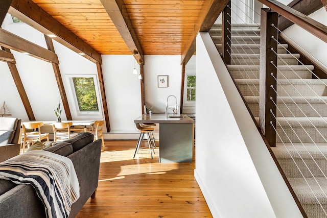 171 Cold Spring Rd, Milton, VT 05478 - living area with hardwood / wood-style floors, healthy amount of natural light, stairway, wooden ceiling with exposed beams, and baseboards