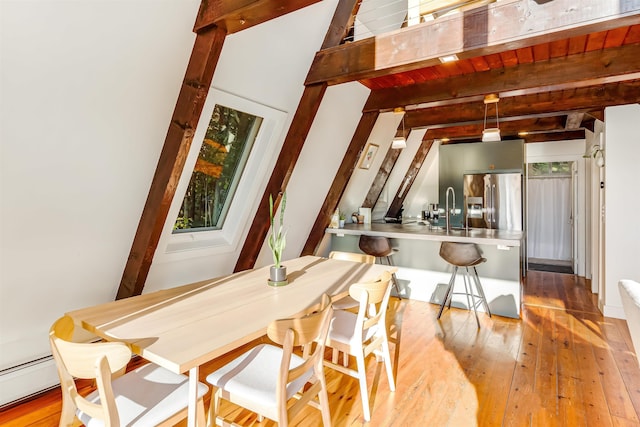 171 Cold Spring Rd, Milton, VT 05478 - dining room featuring beam ceiling, light wood-style flooring, and a baseboard radiator