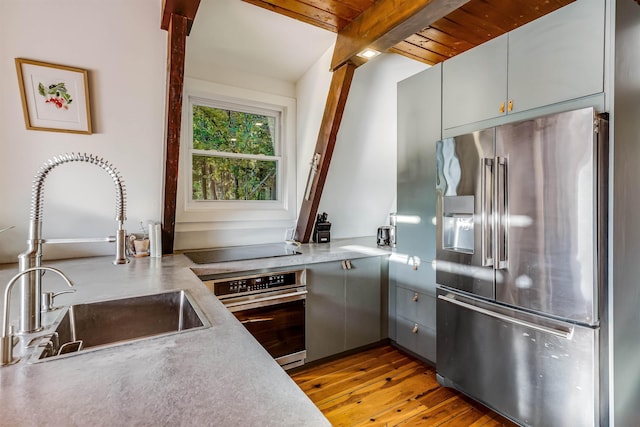 171 Cold Spring Rd, Milton, VT 05478 - kitchen featuring appliances with stainless steel finishes, a sink, hardwood / wood-style flooring, gray cabinetry, and light countertops