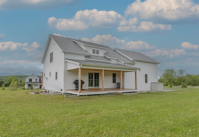 346 Elizabeths Ln Unit 13, Morristown, VT 05661 - back of house with a lawn, roof with shingles, and a deck with mountain view