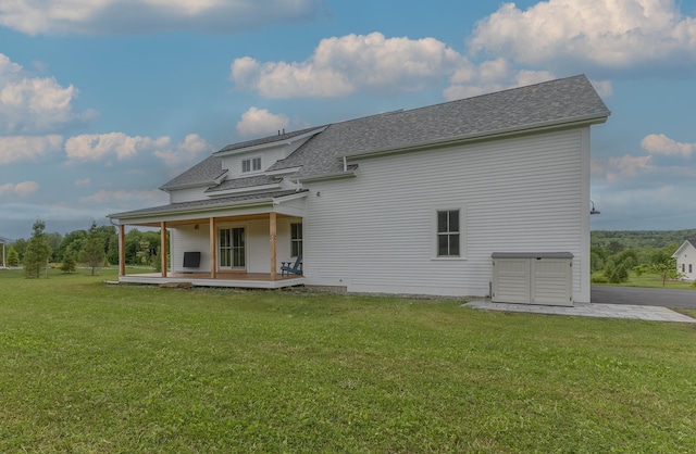 346 Elizabeths Ln Unit 13, Morristown, VT 05661 - back of house featuring a lawn, a shingled roof, and a porch