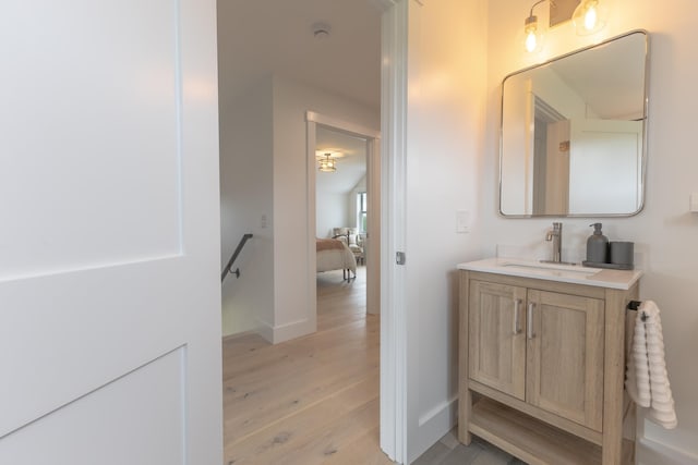 346 Elizabeths Ln Unit 13, Morristown, VT 05661 - bathroom with vanity, wood finished floors, and baseboards