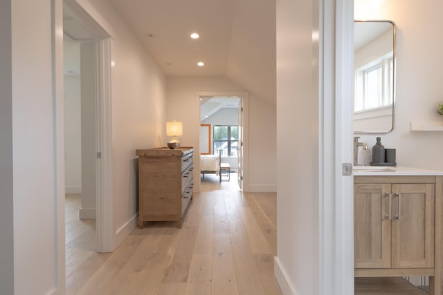 346 Elizabeths Ln Unit 13, Morristown, VT 05661 - hallway featuring light wood-style floors, a sink, lofted ceiling, recessed lighting, and baseboards