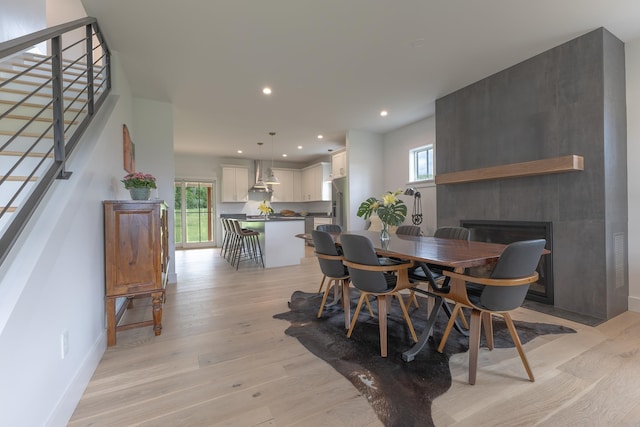 346 Elizabeths Ln Unit 13, Morristown, VT 05661 - dining room with a fireplace, light wood finished floors, stairs, recessed lighting, and baseboards