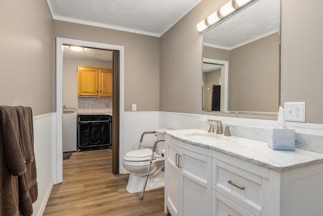 3 Evergreen Way E, Kingston, NH 03827 - bathroom featuring wood finished floors, toilet, vanity, wainscoting, and ornamental molding
